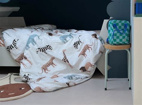 Voorbeelden van Studio Ditte dekbedovertrekken met diverse prints zoals safari dieren, vogels en dino's.