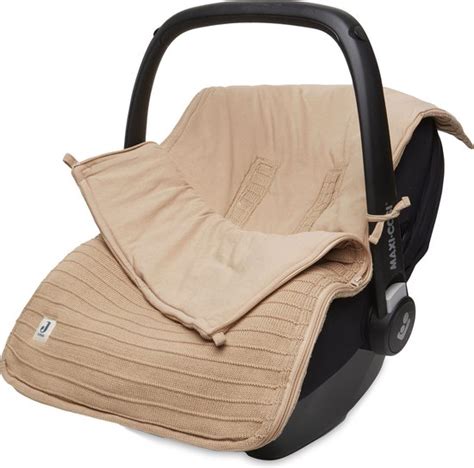 Illustratie van de Maxi-Cosi voetenzak in een autostoeltje, met nadruk op de pasvorm en het fleece materiaal