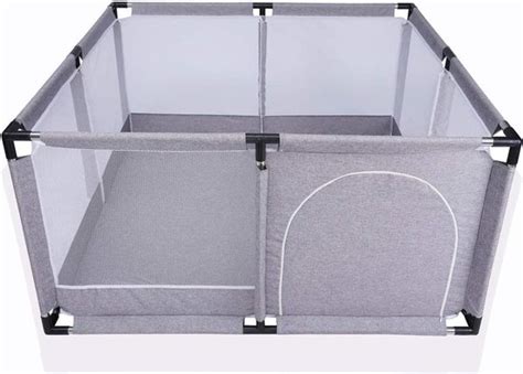 Baby in een moderne box met gaas aan de zijkanten
