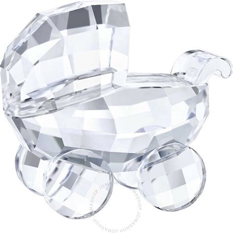Swarovski kristal beeldje van een kinderwagen.