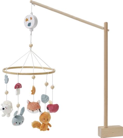 een beige teddy konijn muziekmobiel met een houten ring