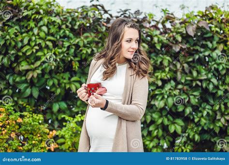 Een zwangere vrouw die ontspannen wandelt in een park.