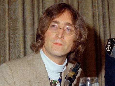 Een iconische foto van John Lennon met zijn gitaar