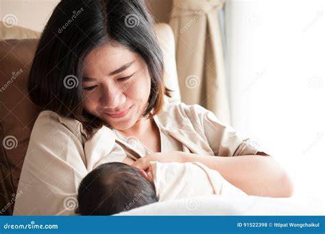 Foto van een moeder die ontspannen haar baby de borst geeft
