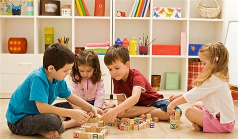 Kinderen van verschillende leeftijden die samen spelen met een speelgoedkeuken.